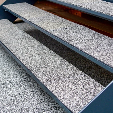 A staircase in an outdoor area made weatherproof and safe by WARCO stair covering.